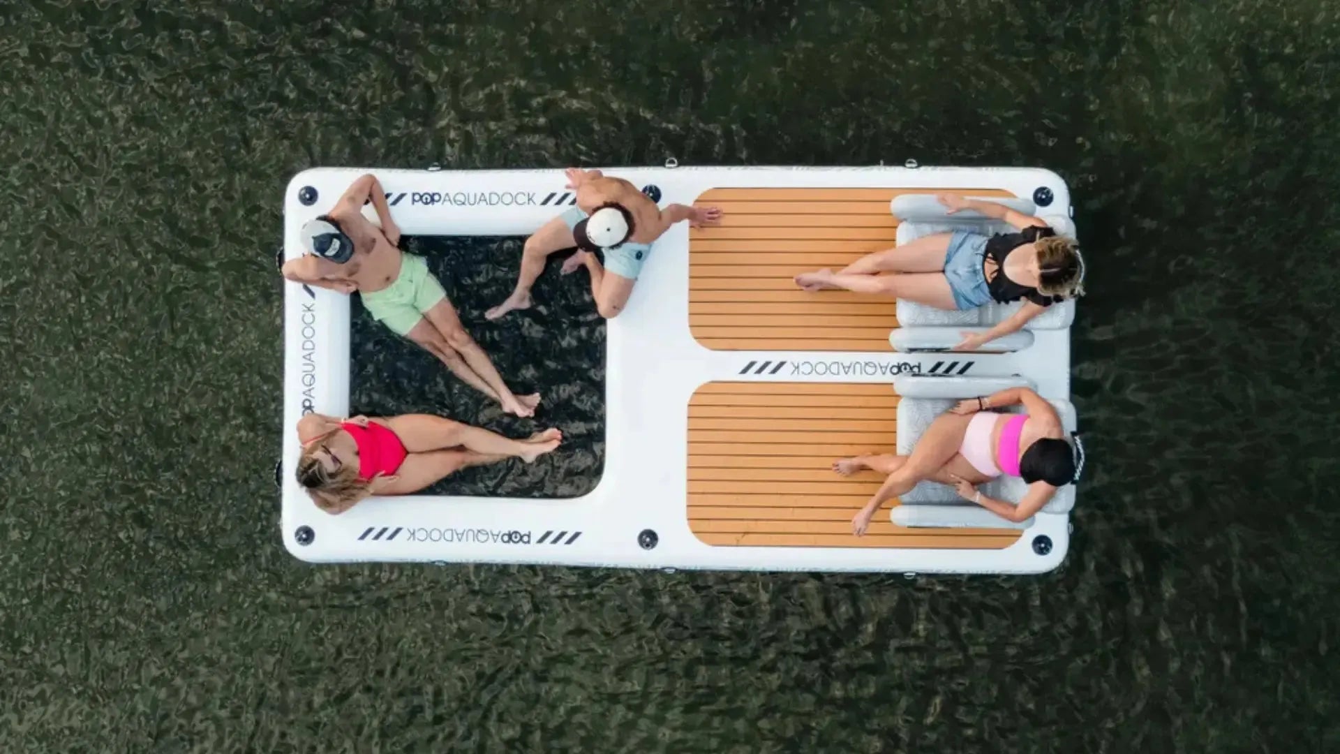 Inflatable popup aqua dock with group relaxing on water