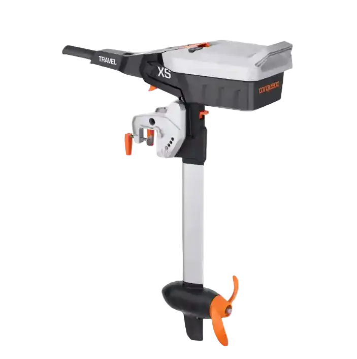 Torqeedo Travel XS electric outboard motor, three-quarter side view showing the tiller handle, motor head with XS branding, transom mount, shaft and orange propeller